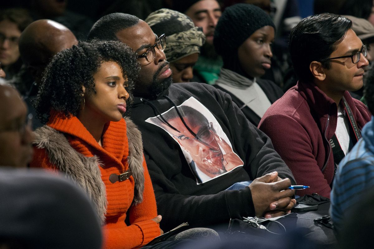 Audience members listen as activists, actors and politicians remember Malcolm X at the site in Harlem where he was killed 50 years ago Saturday. (Associated Press)