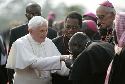 An African clergyman kisses Pope Benedict XVI’s ring as the pope arrives at the airport in Yaounde, Cameroon, on Tuesday. (Associated Press / The Spokesman-Review)
