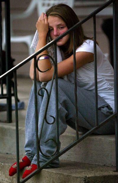 
Mercedez Ivie sits on a North Spokane stoop after watching her friend's mauling by two pit bulls Friday. The boy was taken to an area hospital for the injuries he received to his face. 
 (Amanda Smith / The Spokesman-Review)
