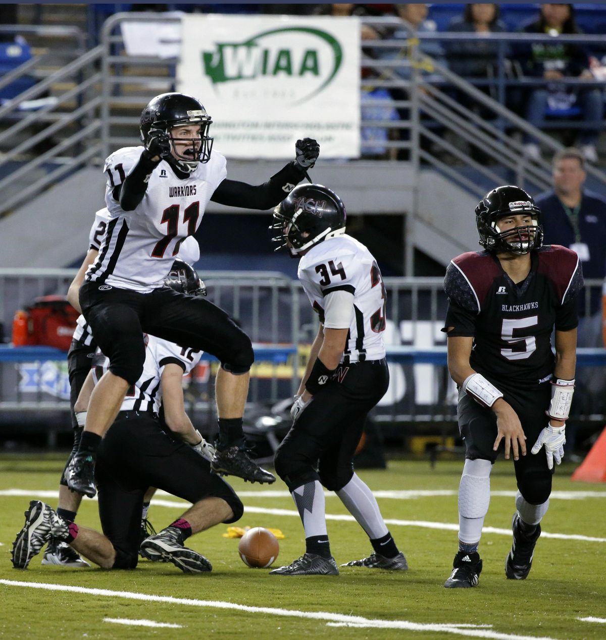 Almira/Coulee-Hartline’s Dallas Isaak (11) celebrates a big play during Friday’s State 1B title game against Lummi Nation.