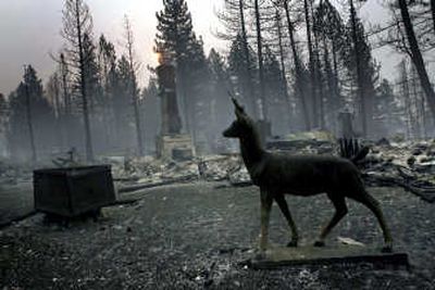 
A statue sits near the remains of a burned home in South Lake Tahoe on Monday.San Francisco Chronicle
 (San Francisco Chronicle / The Spokesman-Review)