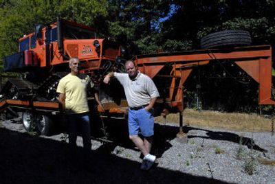 Jim Lemm, left, and Ian Caldwell owners of J&R Electronics stand in front of the cat they use to get to remote locations.
(Kathy Plonka / The Spokesman-Review)