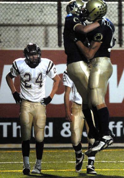 
U-Hi's Dalton Puyear, left, watches as Mead's Matt Lynch celebrates his TD with Dan Spitz, right. 
 (Jed Conklin / The Spokesman-Review)