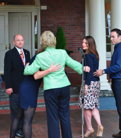 Gov. Chris Gregoire hugs daughters Michelle (left) and Courtney after announcing she won't run for a second term at a press conference with husband Mike and son-in-law Scott Lindsay. (Jim Camden/The Spokesman-Review)