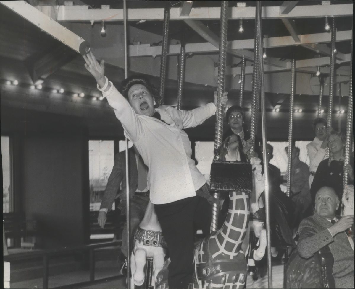 Mrs. Lee Leary reached for a ring while riding the Looff Carrousel at Riverfront Park in May 1975 at a fundraiser for the Spokane Art School. The picture ran on the frontpage of The Spokesman-Review on May 7, 1975. (Spokesman-Review archives)