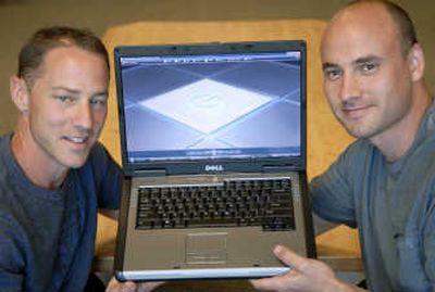 
Jim Schlosser and Cody Peterson of Pacinian LLC in Spokane are developing a flat keyboard that doesn't require vertical keystrokes, illustrated by the image on the screen of this laptop. 
 (Dan Pelle / The Spokesman-Review)