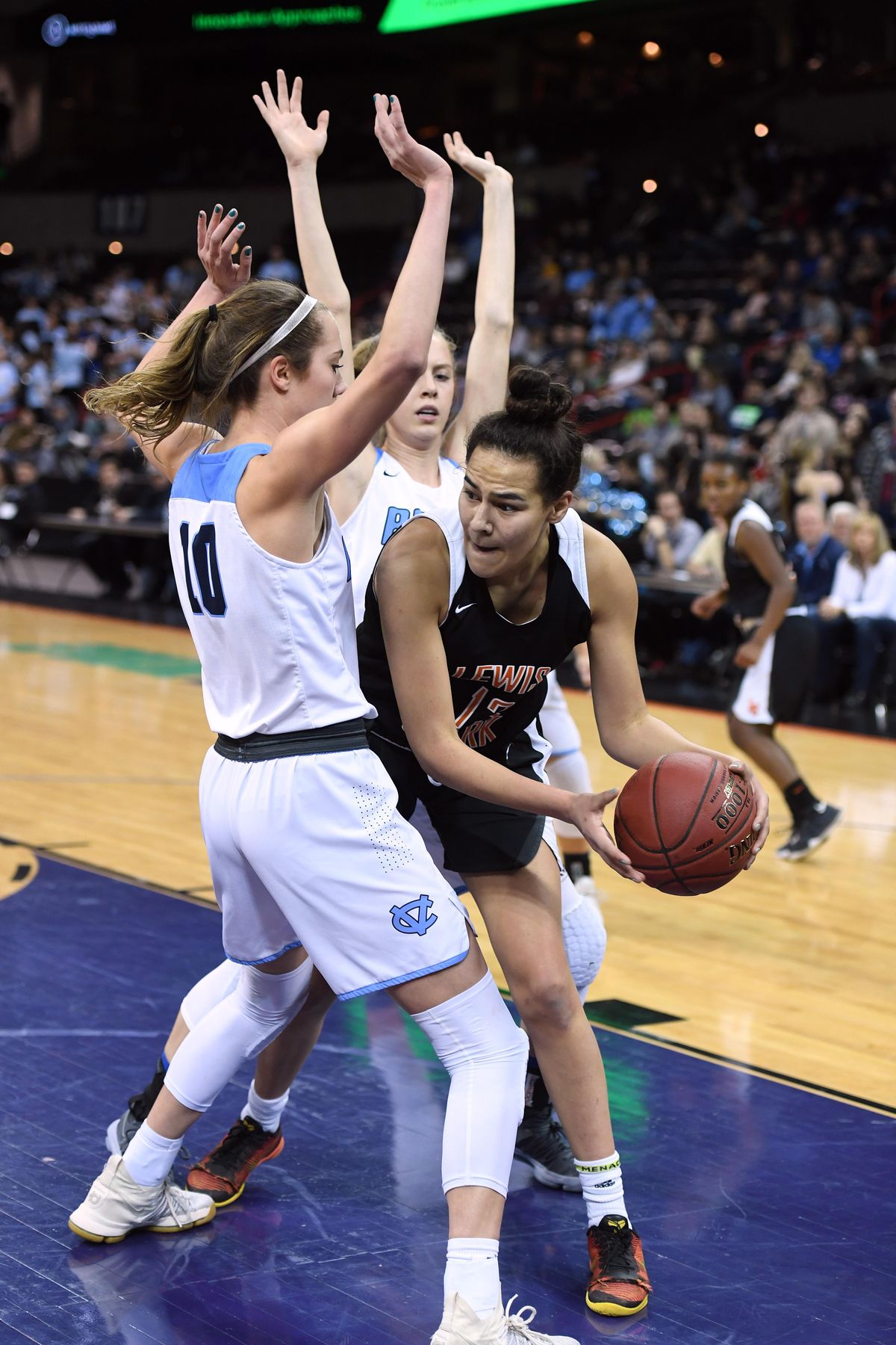 Lewis and Clark’s Jacinta Buckley  looks to pass as Central Valley’s Lexie Hull (10) and Hailey Christopher  defend during the District 8 4A title game on Feb. 16, 2018, in the  Arena. (Colin Mulvany / The Spokesman-Review)