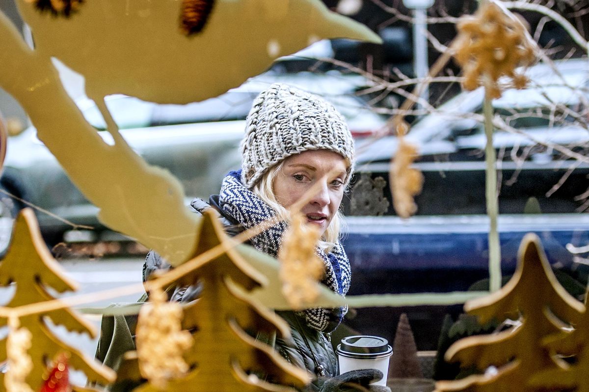 McKenna Phillabaum of Seattle checks out items in the front window of Atticus while visiting family in Spokane during Small Business Saturday on November 24, 2018. (Kathy Plonka / The Spokesman-Review)