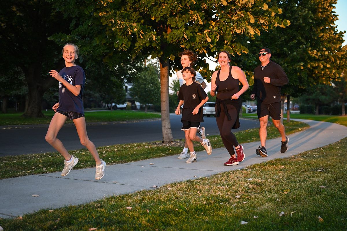 Grace Puntney, 10, leads her family – 15-year-old Max, 13-year-old Miles and her mother and father, Anne and Damian – on their evening 1-mile run near Hart Field on Wednesday.  (COLIN MULVANY/THE SPOKESMAN-REVIEW)