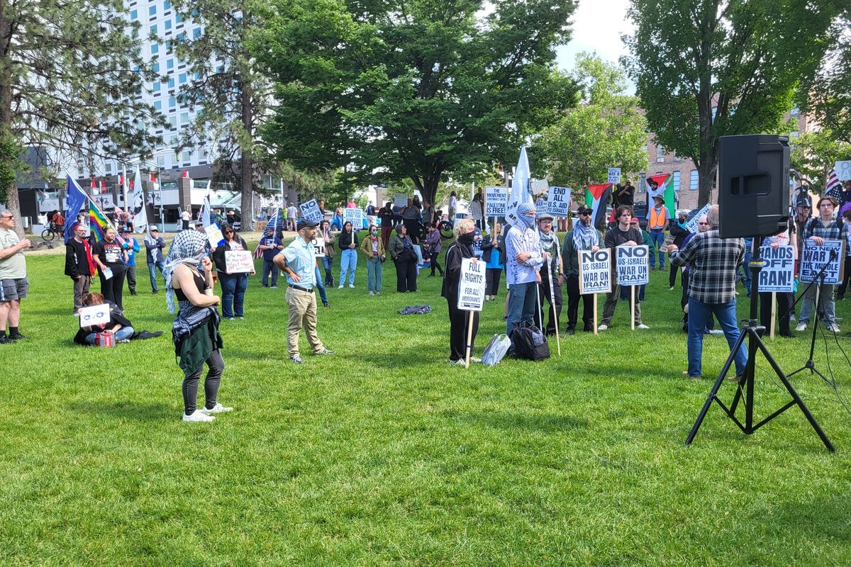 The crowd gathers in front of the speaker near the Big Red Wagon around 3:30 p.m. Sunday in Spokane