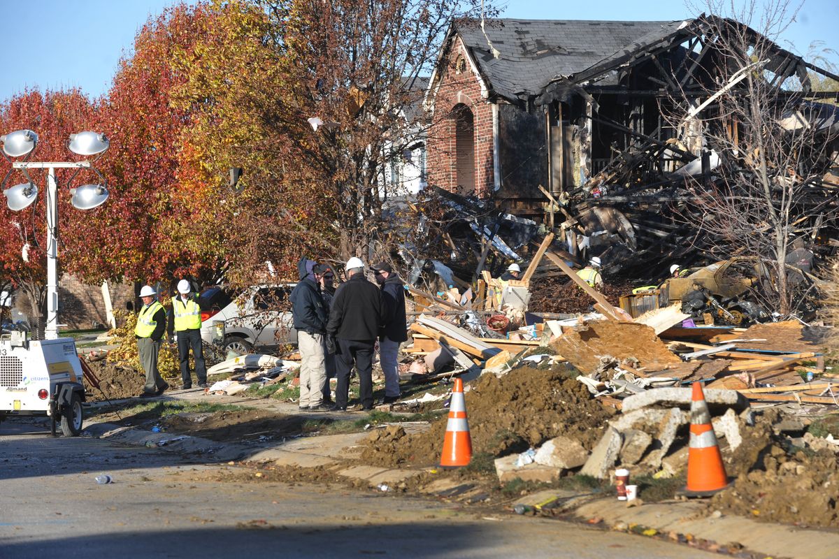Utility workers, and investigators stand outside destroyed homes on Fieldfare Way in the Richmond Hills subdivision Monday, Nov. 12, 2012. An explosion, originating on Fieldfare Way, destroyed or damaged as many as 80 structures in the subdivision late Saturday night November 10, 2012. (Joe Vitti / The Indianapolis Star)
