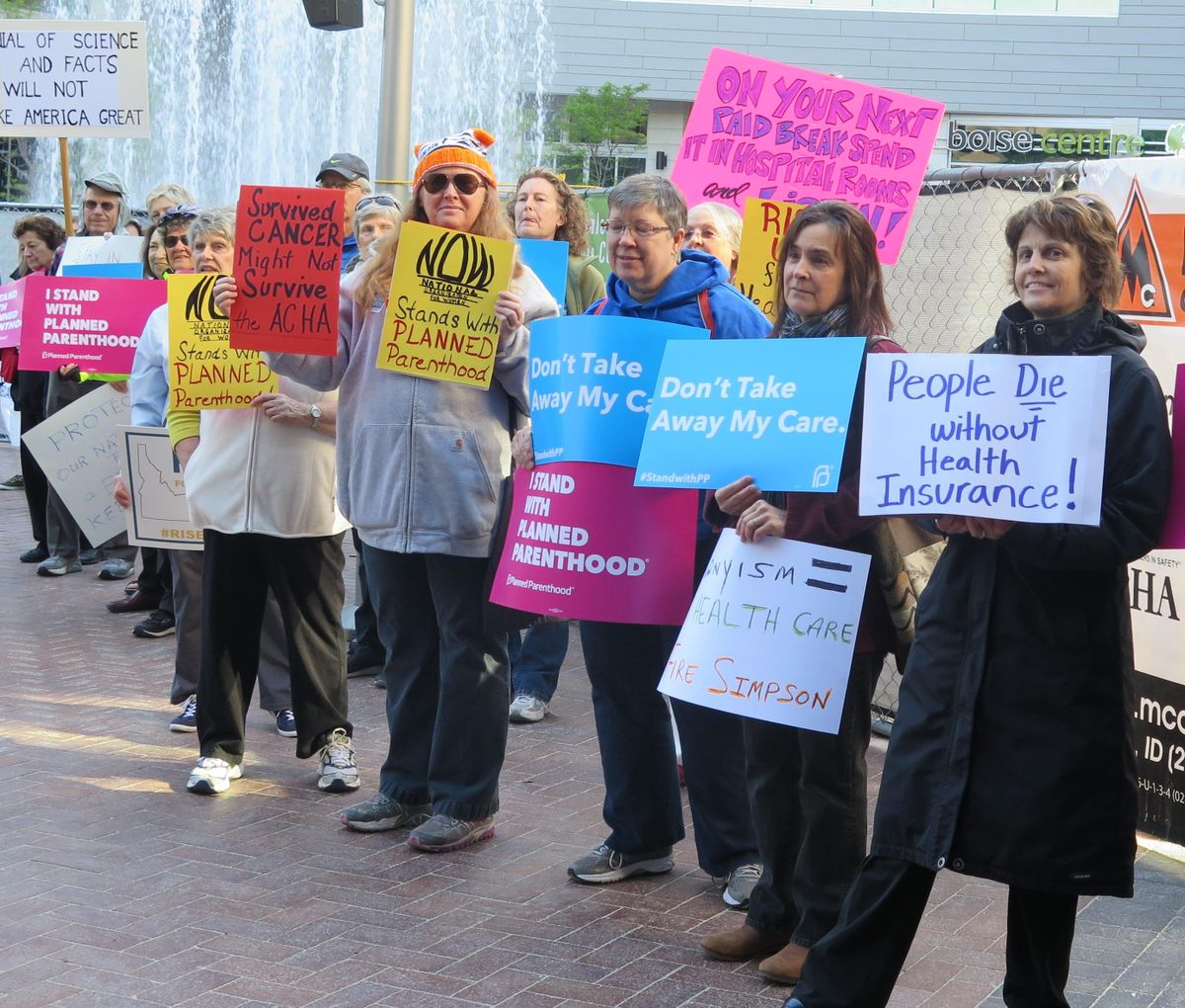 Sign-carrying protesters demonstrate before a health care speech by Idaho Congressman Mike Simpson, Monday, May 15, 2017, in Boise. (Betsy Z. Russell / SR)