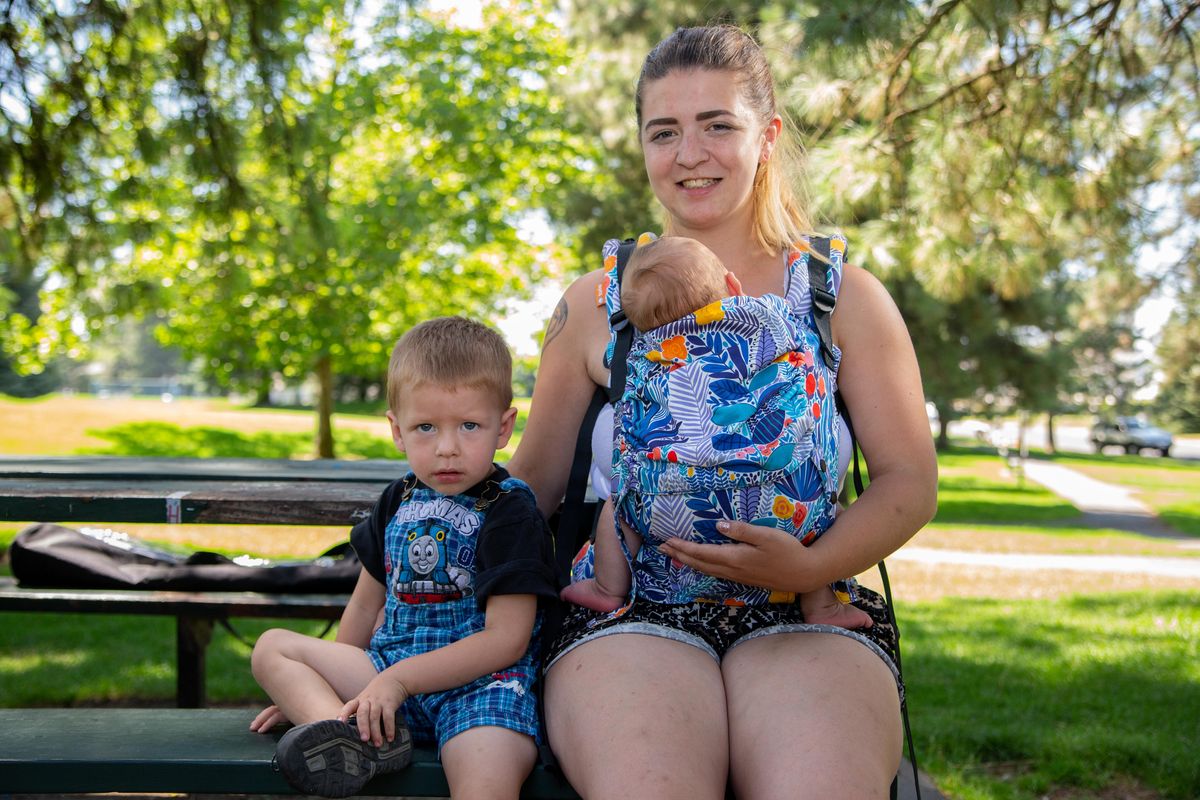Emily Unger, age 22, sits with her 2-year-old son Ricky DeGraaf and 8-week-old son Rayden DeGraaf at Friendship Park on Aug. 1, 2018. Unger is an advocate for breastfeeding. (Libby Kamrowski / The Spokesman-Review)