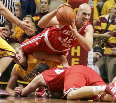 Eastern Washington’s Brandon Moore passes out of a scramble with Minnesota center Colton Iverson during Wednesday’s game.  (Associated Press / The Spokesman-Review)