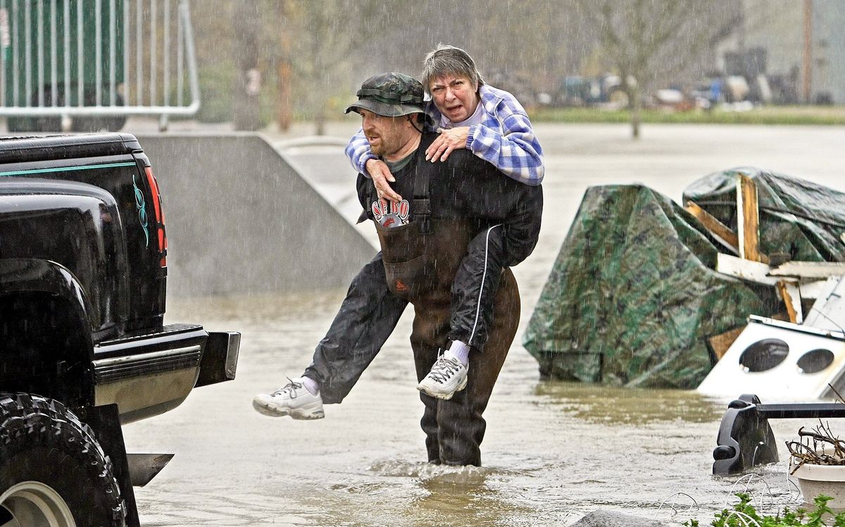 Dave Hunter rescues Linda Farmer from her home in Sultan, Wash., as floodwaters from the Skykomish and Sultan rivers push into low-lying areas Wednesday.Associated Press Photos (Associated Press Photos / The Spokesman-Review)