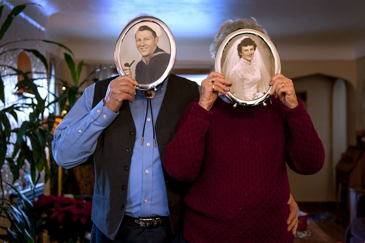 “We’re game for anything,” said Donna Staeb, as she and her husband Bill cover their faces with photos of themselves taken in the 1950s. (Kathy Plonka)