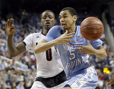 North Carolina's Marcus Paige (5) loses the ball as Louisville's Terry Rozier (0) defends during the second half of an NCAA college basketball game in the quarterfinals of the Atlantic Coast Conference tournament in Greensboro, N.C., Thursday, March 12, 2015. Such events may be pulled from the state in response to North Carolina House Bill 2. (Gerry Broome / Associated Press)