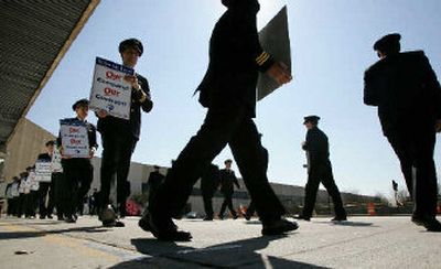 
Delta Airline pilots and members of the Air Line Pilots Association union walk a picket line at Jackson Hartsfield International Airport in Atlanta, earlier this year. 
 (Associated Press / The Spokesman-Review)