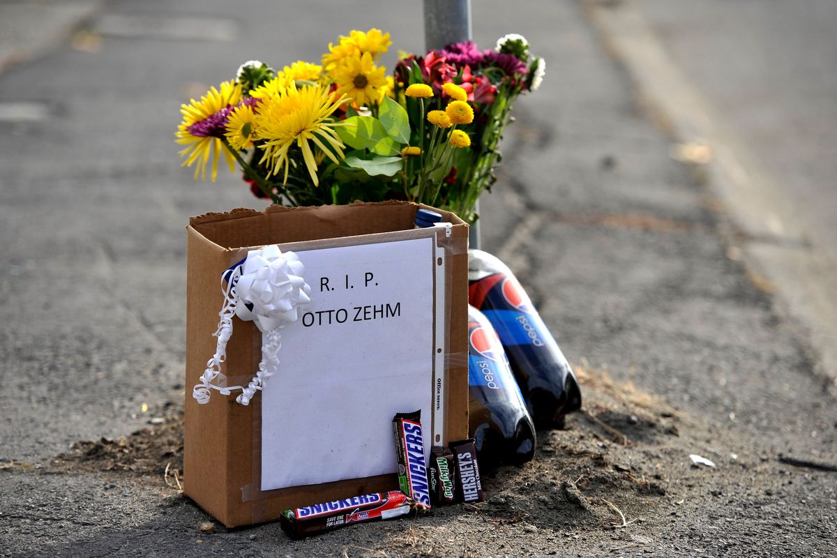 Snickers, flowers and 2-liter bottles of Pepsi are left curbside in November 2011 in front of the Zip Trip where Otto Zehm was beaten by police officers in March 2006. Zehm, who had been incorrectly identified as a robbery suspect, died two days after the beating.  (Dan Pelle/THE SPOKESMAN-REVIEW)