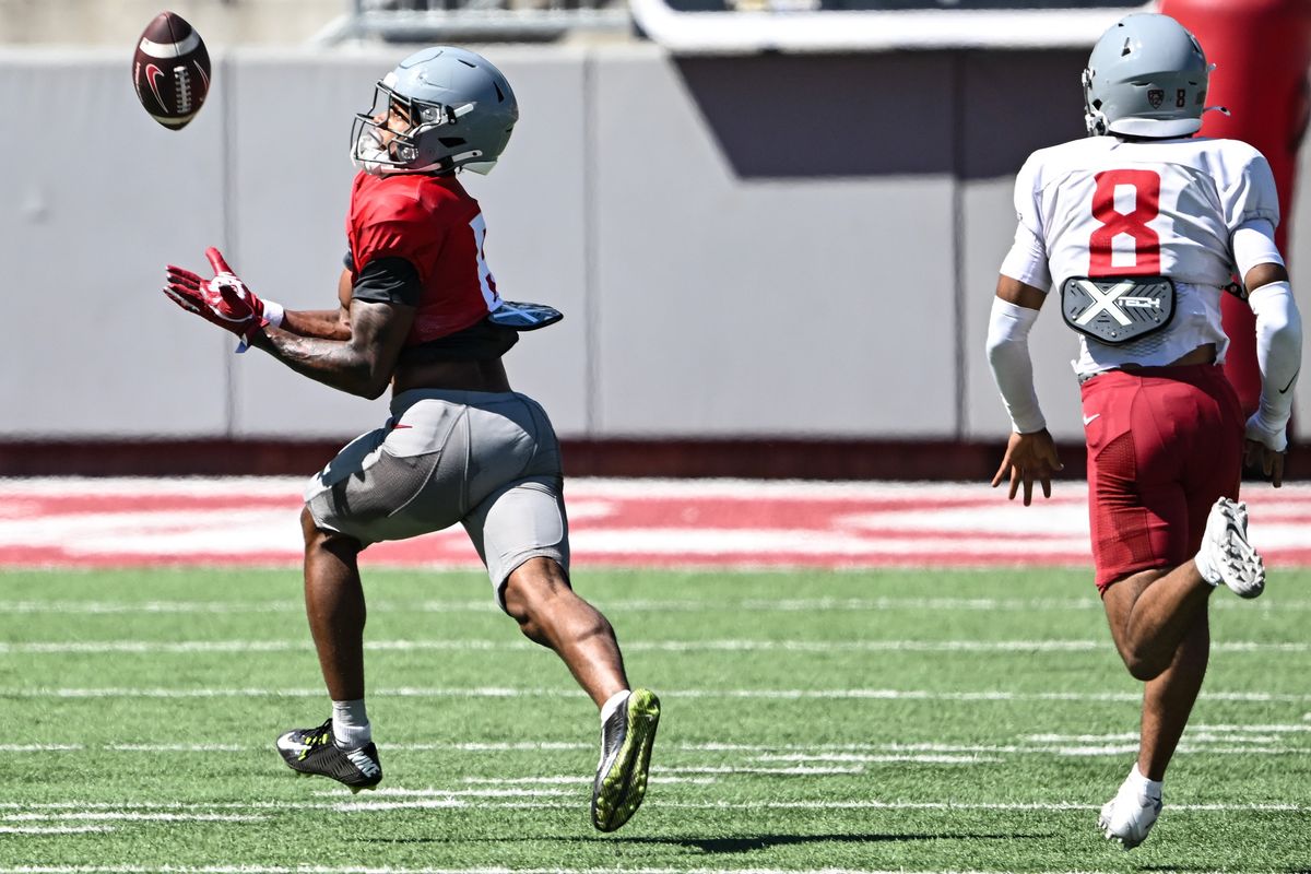 Washington State receiver Devin Ellison catches a touchdown pass ahead of cornerback Kenny Worthy III during practice on Tuesday at Gesa Field in Pullman.  (Tyler Tjomsland/The Spokesman-Review)