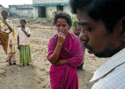 
D. Balasubramanian, headmaster of the Government Elementary School, right, grieves along with Thayal Nayagi, center, who lost three of her four children in the tsunami, and came with her remaining child to school, at Nagappattinam, in the southern Indian state of Tamil Nadu. Others in the photo are unidentified. 
 (Associated Press / The Spokesman-Review)