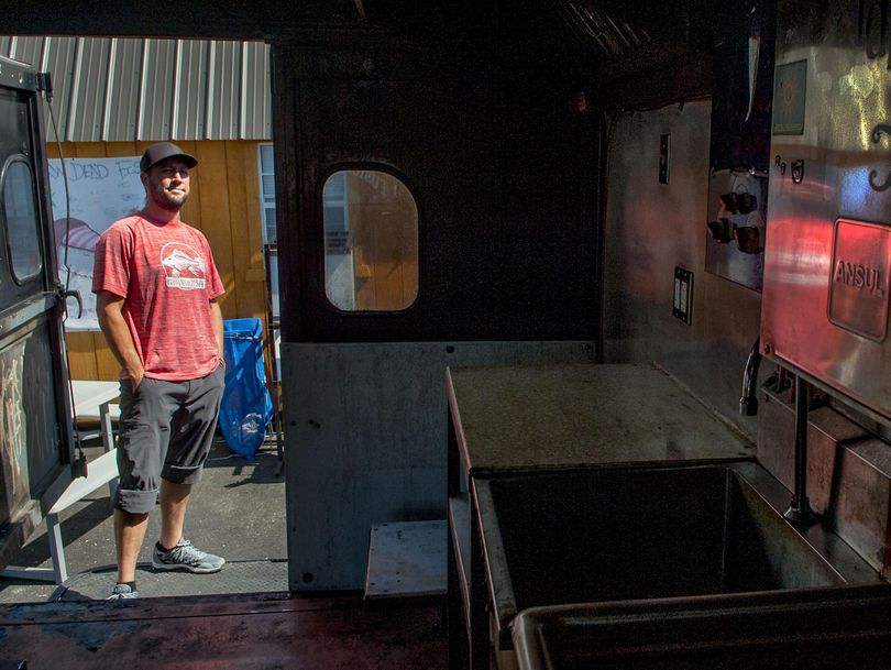 Travis Whiteside, sushi chef and owner of the food truck Rawdeadfish, looks over his food truck, which was damaged in an electrical fire Aug. 14. He’s hoping to rebuild and reopen the popular food truck this fall. An employee has set up a GoFundMe campaign to help offset costs. (Photos by Kathy Plonka kathpl@spokesman.com)