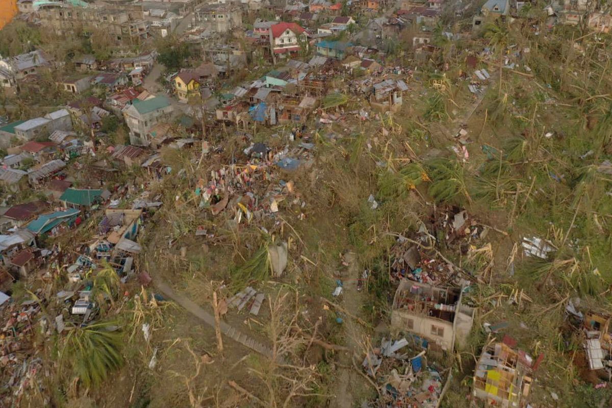 In this photo provided by the Philippine Navy, damaged houses and toppled trees lie in Dinagat Island, Surigao del Norte province, southern Philippines on Friday, Dec. 17, 2021. The governor of an island province in the central Philippines said dozens of people died in the devastation wrought by Typhoon Rai in just half of the towns that managed to contact him, bringing the death toll in the strongest typhoon to batter the country this year to nearly 100.  (HOGP)
