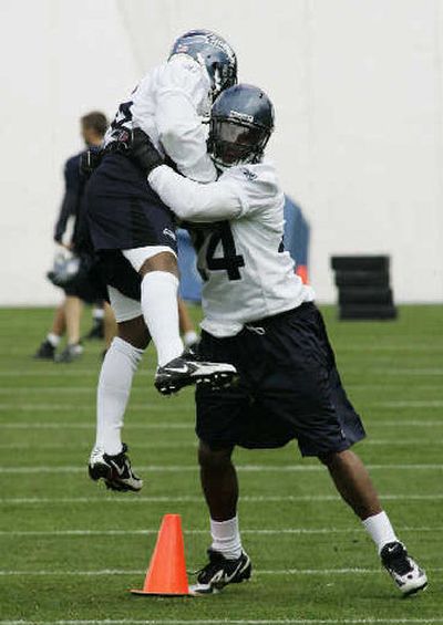 
Deon Grant, right, welcomes cornerback Josh Wilson to the NFL.
 (Associated Press / The Spokesman-Review)