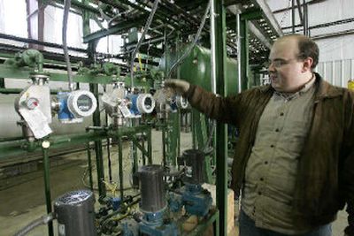 
Nicholas Pavelka, a chemist with Global Fuels refinery in Dexter, Mo., demonstrates the process of refining animal byproducts into biodiesel fuel. 
 (Associated Press / The Spokesman-Review)