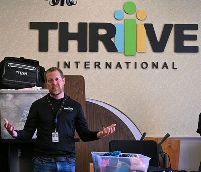 Mark Finney, executive director of Thrive International in Spokane, welcomes credit union volunteers to a work day event at Thrive on Oct. 19, 2023. Thrive announced on Wednesday, March 20, 2024, that it will partner with the Spokane Public Library to build affordable housing at 6980 N. Nevada St. in north Spokane.  (DAN PELLE/THE SPOKESMAN-REVIEW)
