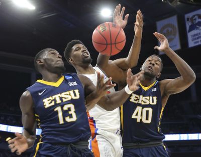 East Tennessee State guard A.J. Merriweather (13) and forward Tevin Glass (40) scramble for a loose ball against Florida forward Kevarrius Hayes, center, during the first half of the first round of the NCAA college basketball tournament, Thursday, March 16, 2017 in Orlando, Fla. (Gary McCullough / Associated Press)