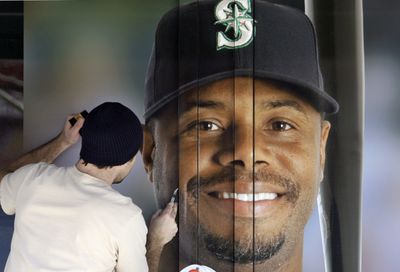 Kyle Birch installs a likeness of Ken Griffey Jr. on a large window at Safeco Field in Seattle.  (Associated Press / The Spokesman-Review)