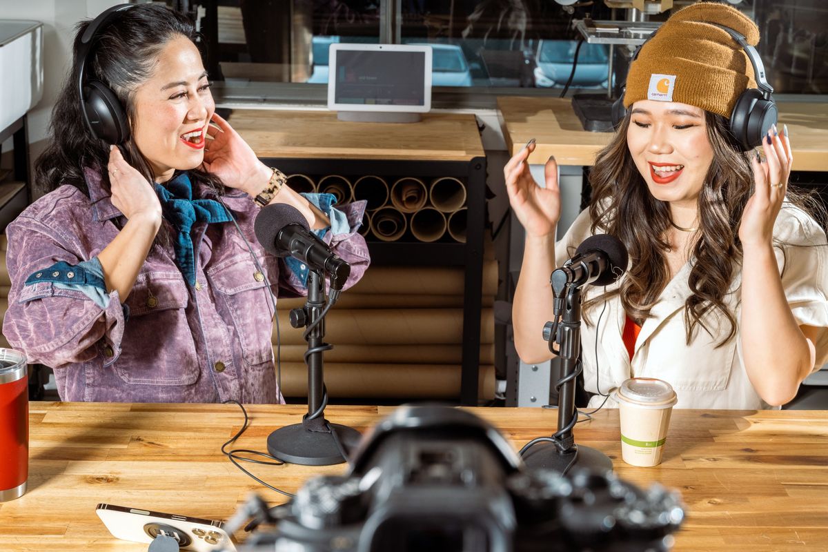 Ann Duskus, left, and Vicky Vuong work in their office studio in San Francisco last month. Duskus and Vuong are sneaker artists who equipped their office with a studio for giving online classes, taking product shots and recording unboxing videos.   (New York Times)