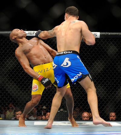 Chris Weidman sends Anderson Silva to the mat in the second round. (Associated Press)