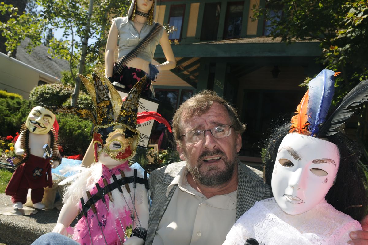 Jim Mahoney poses Thursday with some of the mannequins he has put in the front yard of his south Spokane home to protest a condo tower.  (Photos by Christopher Anderson / The Spokesman-Review)