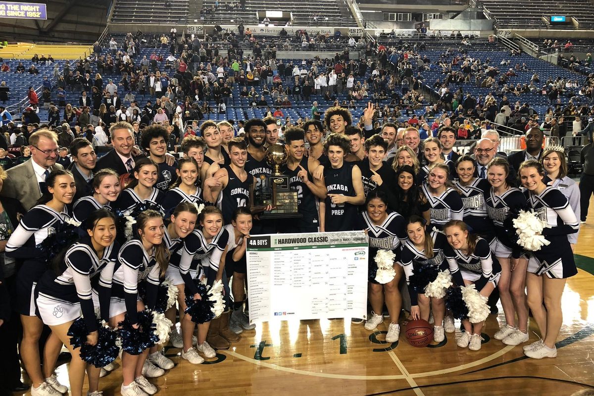 The Gonzaga Prep Bullpups, 2018 boys 4A state champions pose with the trophy at the Tacoma Dome on Saturday, March 3, 2018. (Dave Nichols / The Spokesman-Review)