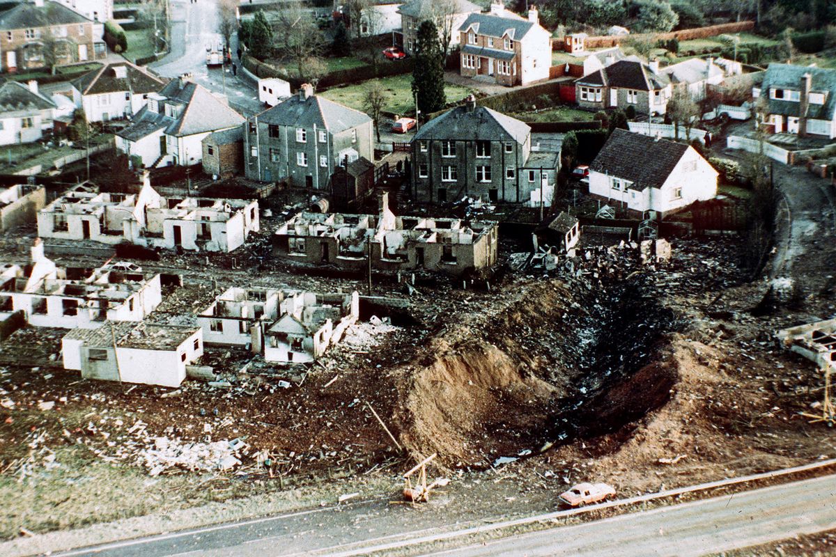 FILE - This December 1988 file photo shows wrecked houses and a deep gash in the ground in the village of Lockerbie, Scotland, after the bombing of the Pan Am 103 in the village of Lockerbie, Scotland. The Justice Department expects to unseal charges in the coming days in connection with the 1988 bombing of a Pan Am jet that exploded over Lockerbie, Scotland, killing 270 people, according to a person familiar with the case.  (Martin Cleaver)