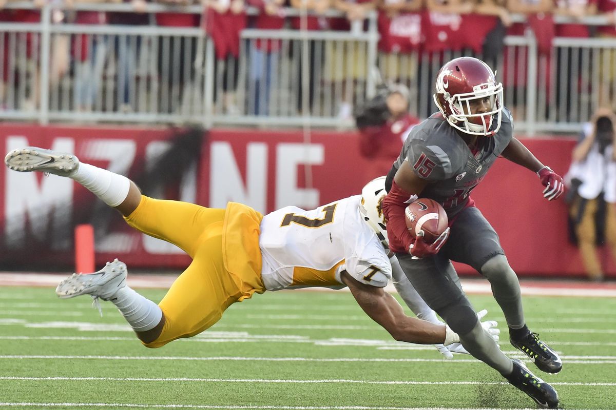 Washington State receiver Robert Lewis (15) slips a Wyoming tackle during the first half of a college football game on Saturday, Sep 19, 2015, at Martin Stadium in Pullman, Wash. (Tyler Tjomsland / The Spokesman-Review)