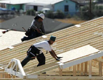 
Carpenters build a home at a new real estate development in Tucson, Ariz., on Thursday. Construction of new homes and apartments shot up 14.5 percent in January to the fastest pace since March 1973. 
 (Associated Press / The Spokesman-Review)
