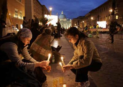 
Pilgrims light candles along the street leading to St. Peter's Basilica, at the Vatican, on Thursday. Police reopened the line to the basilica, giving the faithful a final chance to pay respects to Pope John Paul II. 
 (Associated Press / The Spokesman-Review)