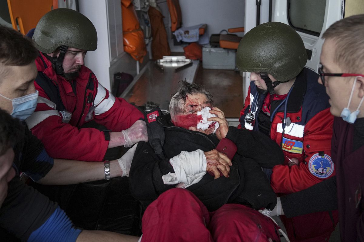 FILE - Ambulance paramedics move a civilian wounded in shelling onto a stretcher to a maternity hospital converted into a medical ward in Mariupol, Ukraine, March 2, 2022. A bipartisan group of U.S. lawmakers is calling on the Biden administration to establish field hospitals near Ukraine