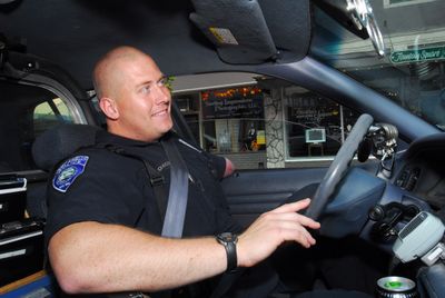 Port Angeles police Officer Mike Johnson drives his cruiser through downtown Saturday.  (Associated Press / The Spokesman-Review)