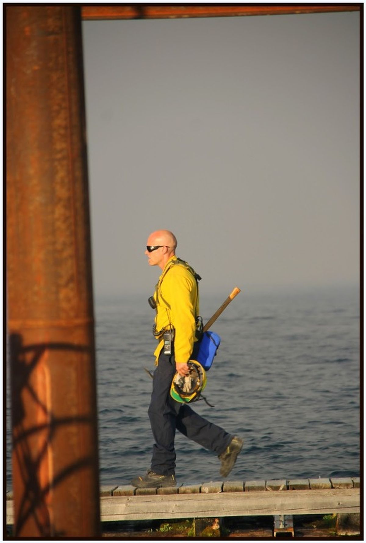Firefighter walks along a dock at Bayview. (Marianne Love/Slight Detour)