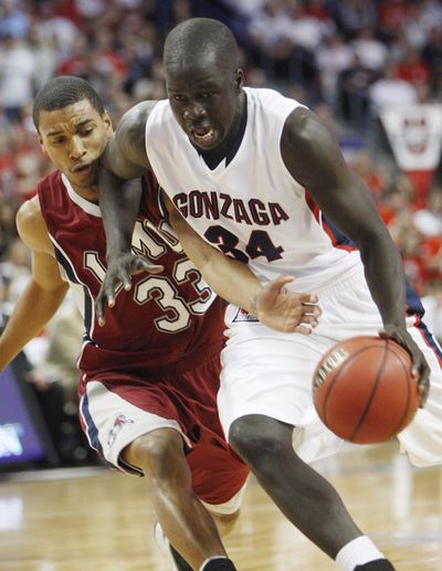 Gonzaga's Bol Kong, right, drives up the court covered by Loyola Marymount's Larry Davis during the first half of an NCAA college basketball game at the West Coast Conference tournament Sunday, March 7, 2010, in Las Vegas. (Isaac Brekken / Fr159466 Ap)