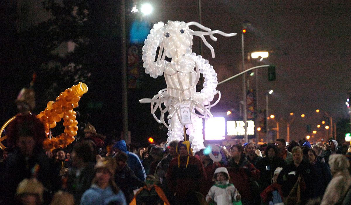The Masquerade Parade, made up of kids, families and an occasional balloon sculpture, moves down Spokane Falls Boulevard at last year’s First Night, the New Year’s Eve celebration in downtown Spokane. (Jesse Tinsley / The Spokesman-Review)