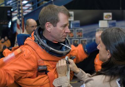 Gregory Johnson tries on a launch and entry suit at Johnson Space Center in Houston, with help from Toni Cost-Davis, in January 2008. NASA, via the Seattle Times (NASA, via the Seattle Times / The Spokesman-Review)