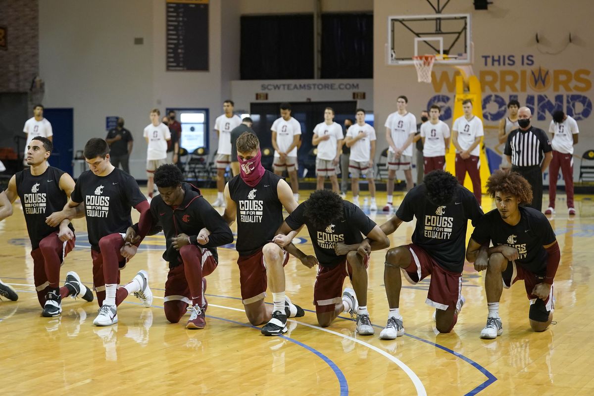 Washington State players kneel during the national anthem in front of standing Stanford players before an NCAA college basketball game in Santa Cruz, Calif., Saturday, Jan. 9, 2021.  (Associated Press)