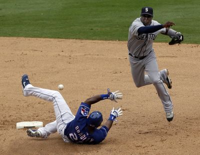 Seattle’s Yuniesky Betancourt forces out  Hank Blalock en route to a double play.  (Associated Press / The Spokesman-Review)