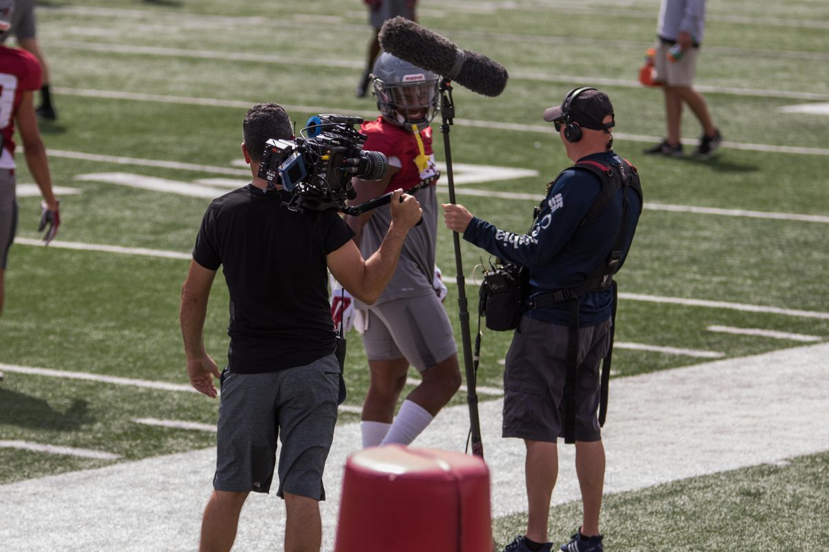Cougars wide receiver Calvin Jackson Jr. smiles as he walks past HBO crew members during a Washington State scrimmage in August. (Courtesy/Jack Ellis)