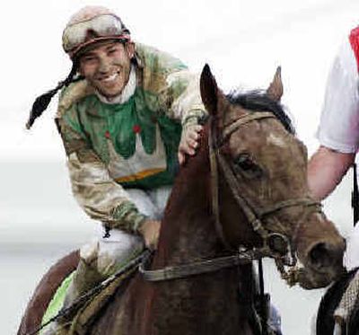 
Jeremy Rose offers a congratulatory pat to Afleet Alex on their way toward the winner's circle at Pimlico. 
 (Associated Press / The Spokesman-Review)
